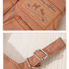 Close-up of a tan dog denim jumpsuit featuring a branded patch and a silver buckle detail.