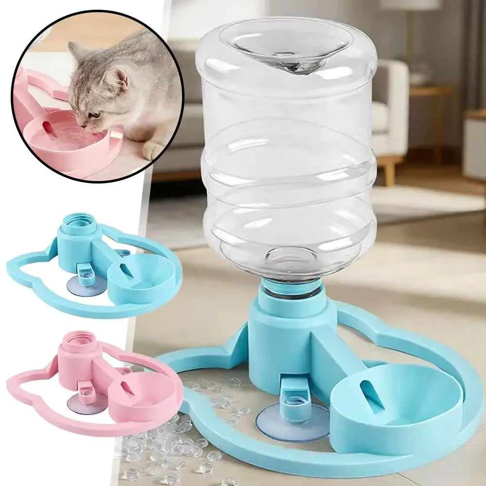 A clear gravity cat water dispenser with multiple bowls and a pink and blue silicone feeding mechanism.