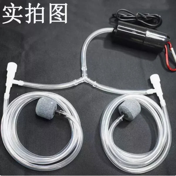 A clear tubing system with two small, gray aeration stones connected to a black pump for an aquarium oxygen system.