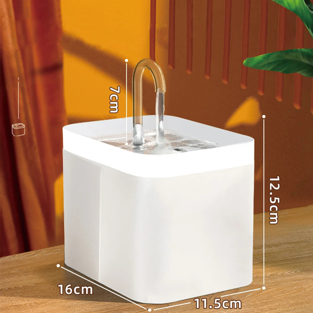 A white pet water fountain with a curved spout is shown on a wooden surface, highlighting its dimensions.
