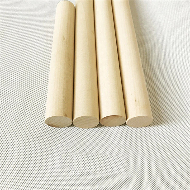 A set of five natural wood hanging perches or dowels arranged in a vertical line on a light surface.