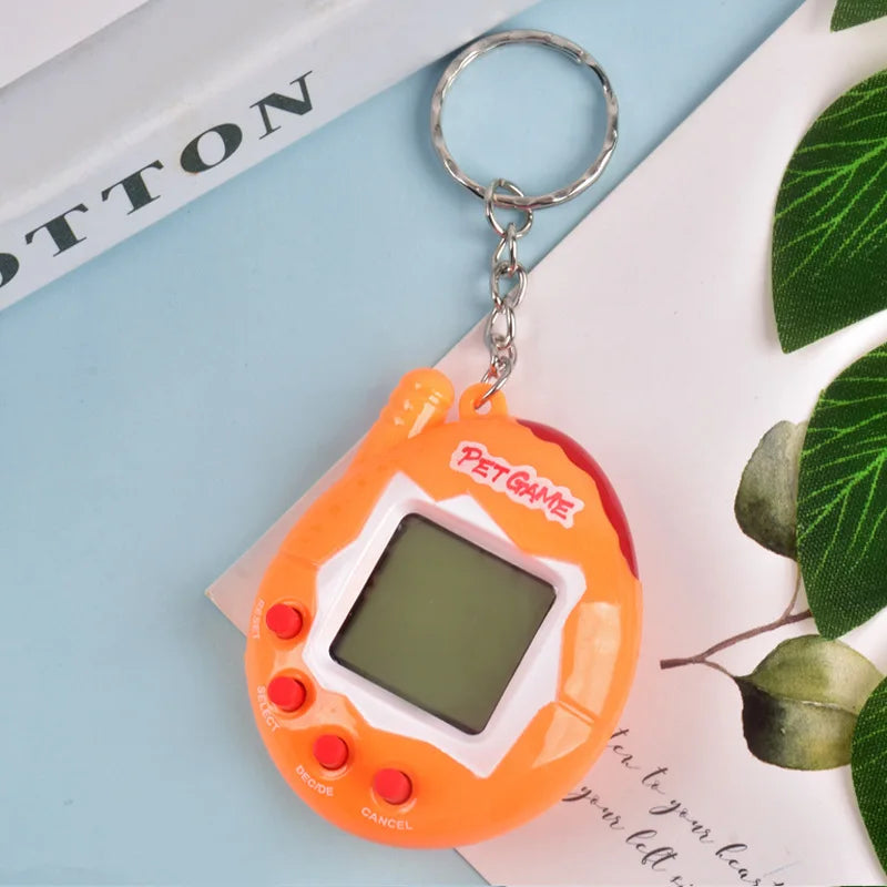 An orange digital pet toy with a clear screen and metal keyring is shown on a white background.