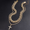 A set of dainty diamond Cuban link necklaces featuring gold-toned chains and a cross pendant.