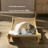 A fluffy orange and white cat is relaxing on a natural fiber sisal scratcher and lounge bed.