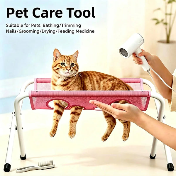A cat is resting on a pink foldable pet grooming hammock used for bathing, trimming nails, and grooming.
