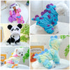 A fluffy white plush fleece pet overalls for a dog, featuring pink and purple accents.