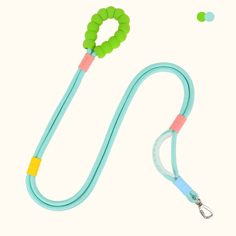 A light blue adjustable hands-free dog leash with a green handle and clip.