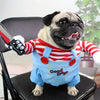 A pug wearing a blue Halloween costume with red stripes and a knife accessory.