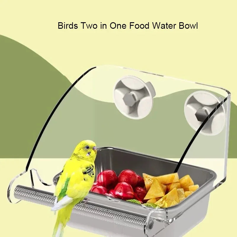 A clear glass bowl with a stainless steel feeding tray holds two birds for food water.