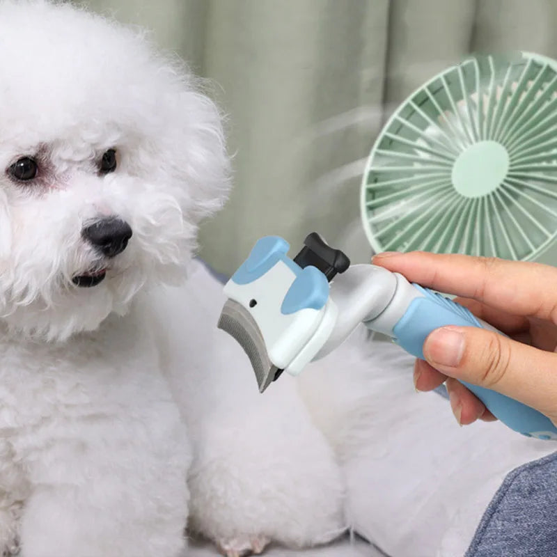 A hand is using a white and blue pet thinning comb on a fluffy white dog while a green fan is in the background.