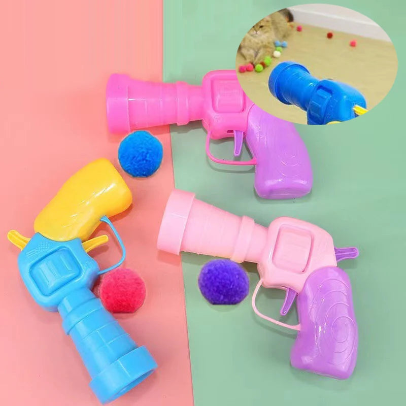 A collection of colorful plush ball launchers for cats, including pink, purple, and yellow versions.