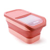 A pink collapsible airtight pet food storage container with a clear sealed lid.