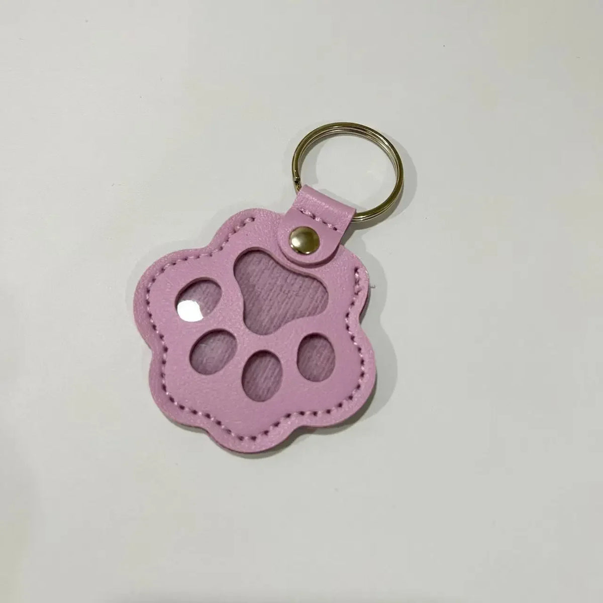 Pink leather pet paw print keychain charm with a silver ring.