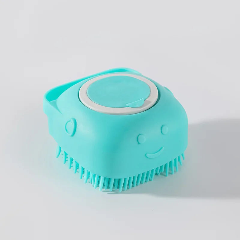A teal pet bath massage brush with a shower gel dispenser is shown against a light gray background.
