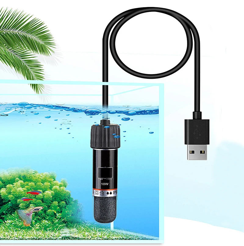 A black USB mini aquarium heater with a coiled wire is shown above an underwater scene of aquatic plants and fish.