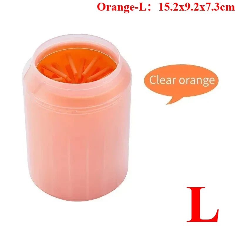 A pink portable paw washer cup with an orange silicone bristled insert.