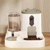 A white gravity pet food and water dispenser with a clear water tank and a compartment for dry food.