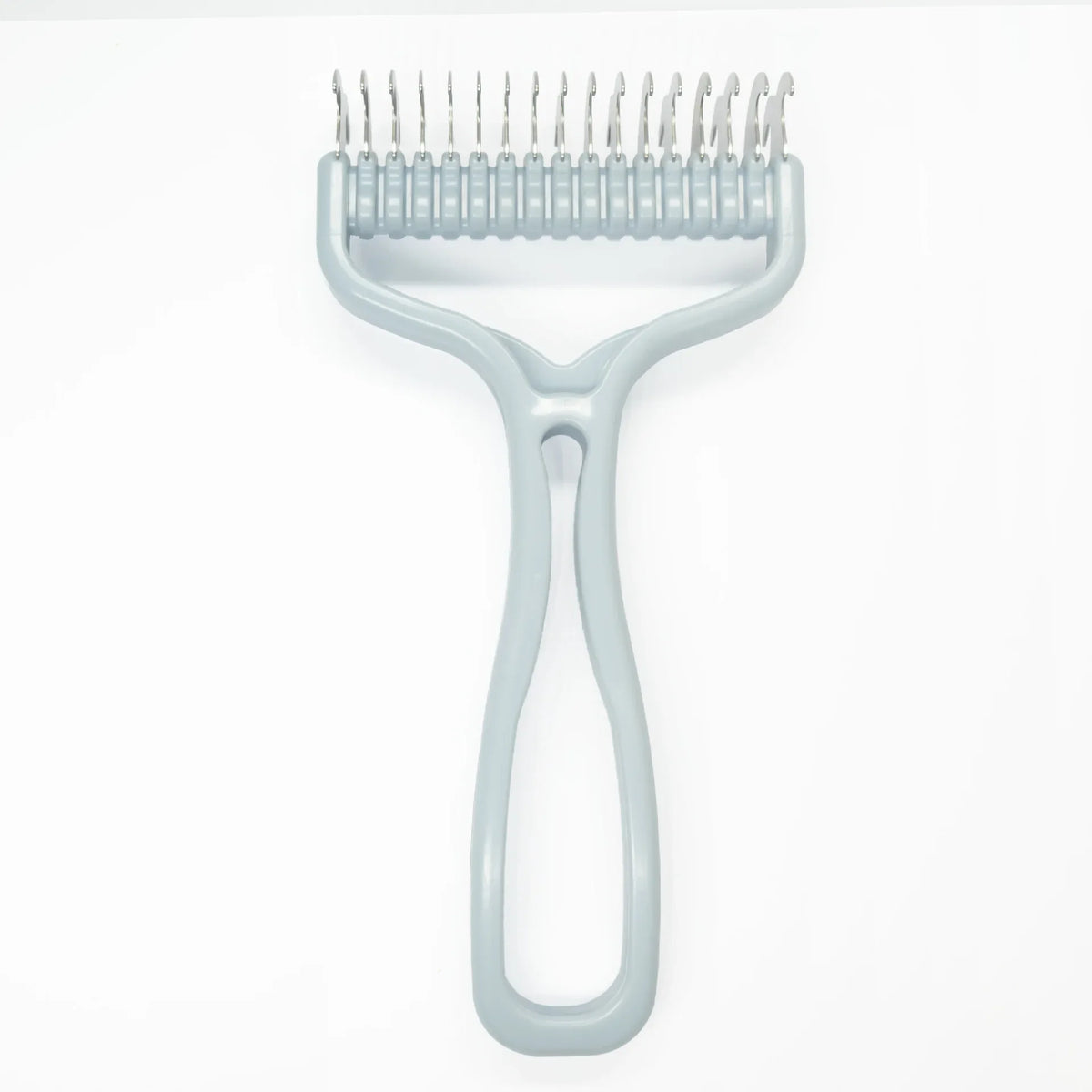 A light blue pet grooming brush with a metal comb attachment and a handle for knot removal.