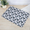 A rectangular washable pet training mat featuring a repeating pattern of gray and white cats on a light background.