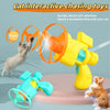 A yellow cat interactive chasing toy launcher is shown with an orange disc, a blue disc, and a small orange disc flying in mi