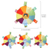 A colorful plush dog toy shaped like a flying disc with various colored petals and an embroidered face.