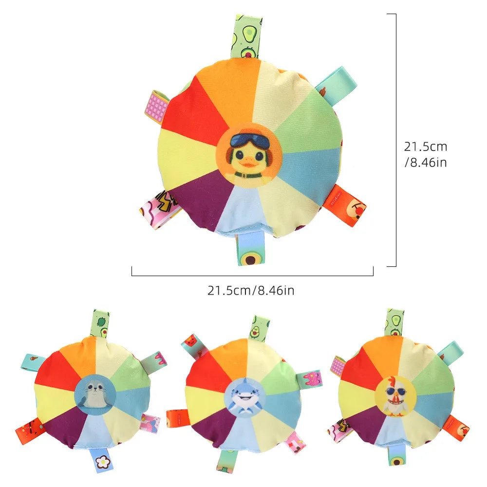 A colorful plush dog toy shaped like a flying disc with various colored petals and an embroidered face.