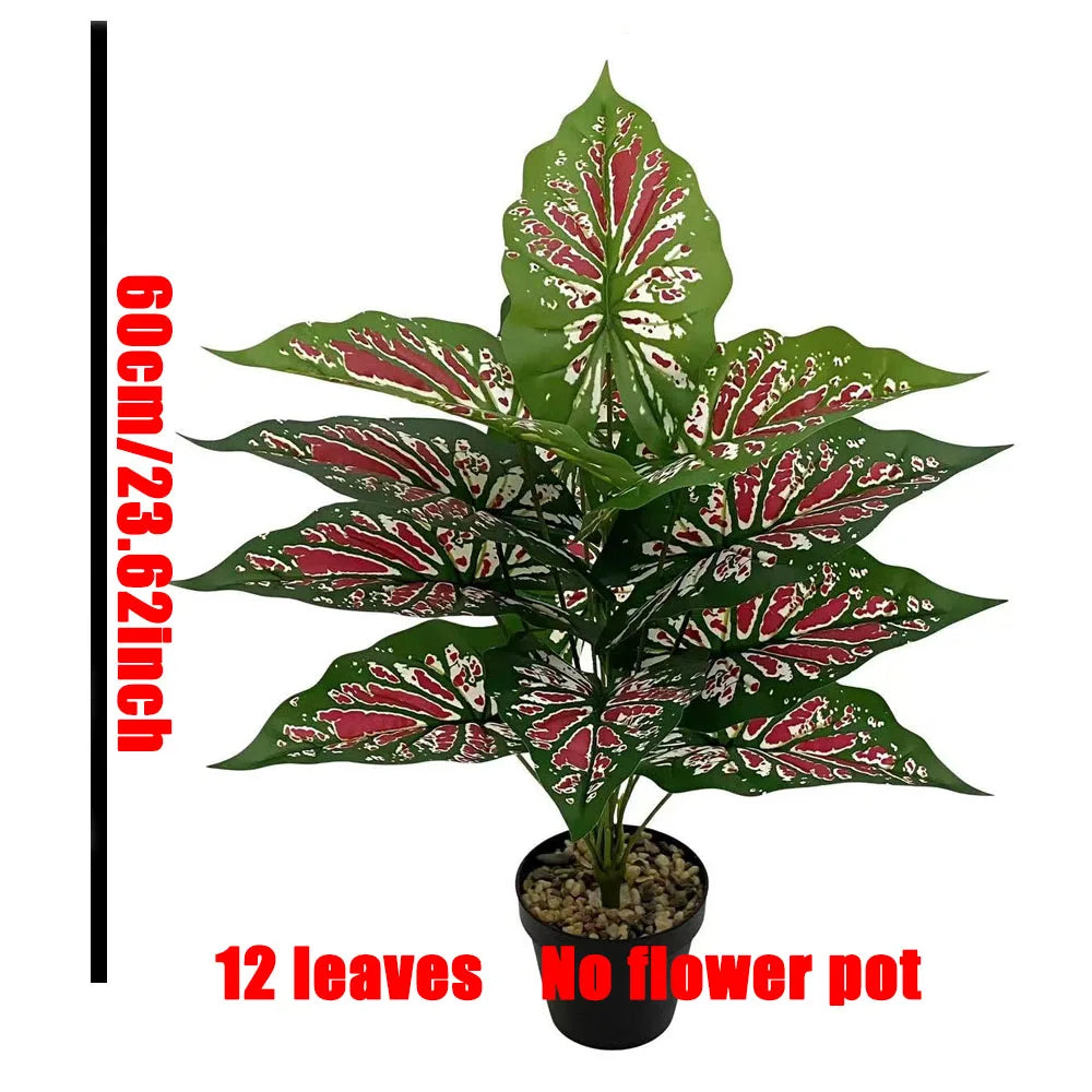 A potted artificial Monstera plant with 12 green leaves and red accents.