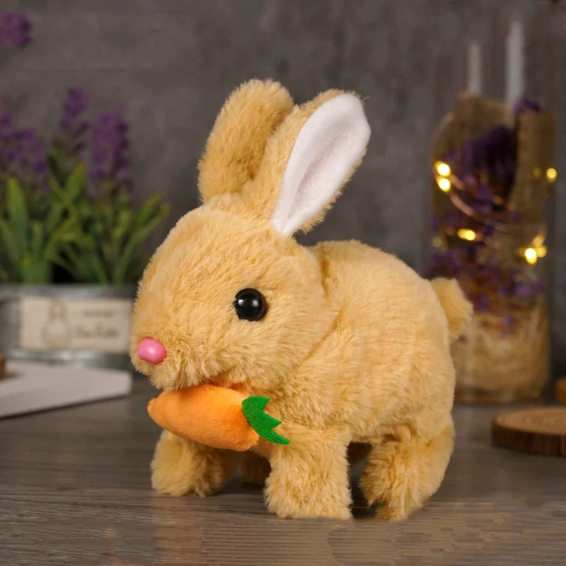 A fluffy golden bunny plush toy with pink nose and green carrot accessory sitting on a wooden surface.