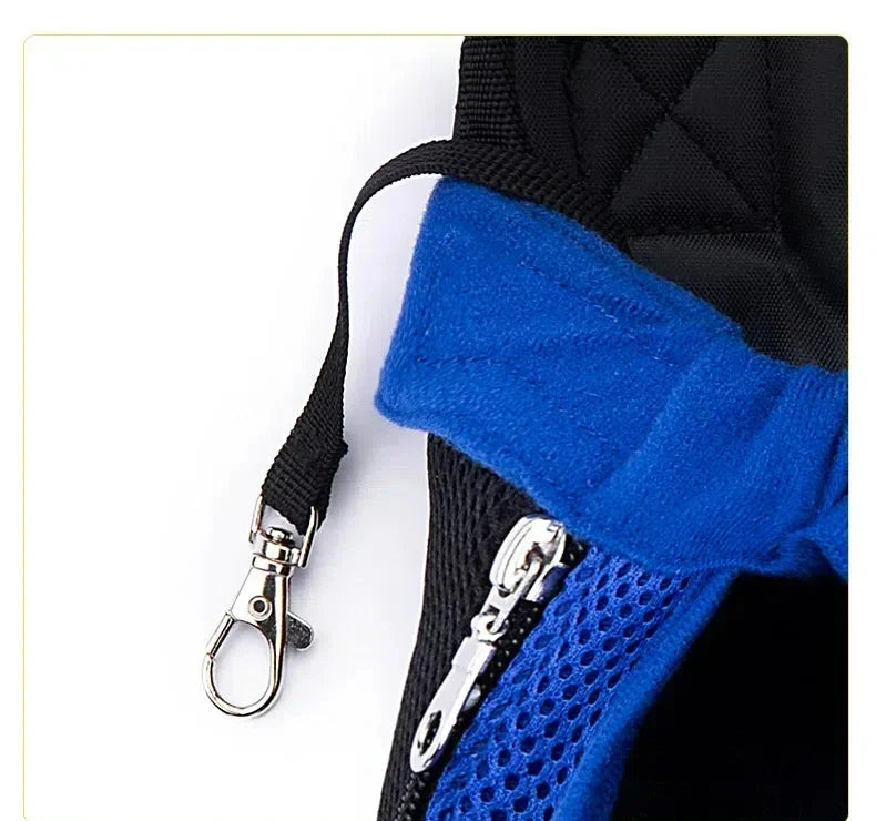 A close-up of a black and blue breathable mesh pet carrier backpack with a silver clip.