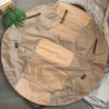 A tan foldable travel organizer bag with a matching picnic mat laid out on a dark surface.