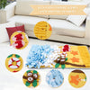 A yellow pet sniffing training blanket with various fabric pieces and a red dog toy on a white sofa.