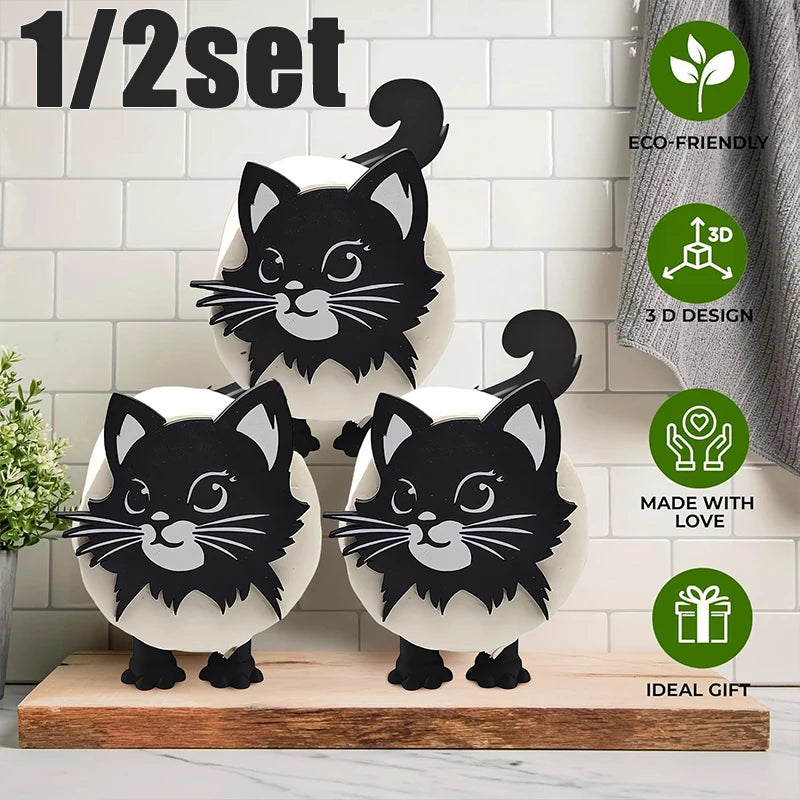 A set of 3D printed black cat figurines with white bodies and gray accents displayed on a wooden surface.
