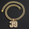 A gold-toned Cuban link chain necklace featuring a large pendant shaped like the number 39.