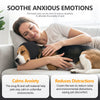 A woman is gently holding a dog while wearing a black calming ear cover to soothe anxious emotions.
