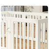White indoor pet playpen with vertical slats shown on a wooden floor.