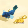 A blue and teal interactive bird chasing toy for cats with a fluffy tail and yellow string.
