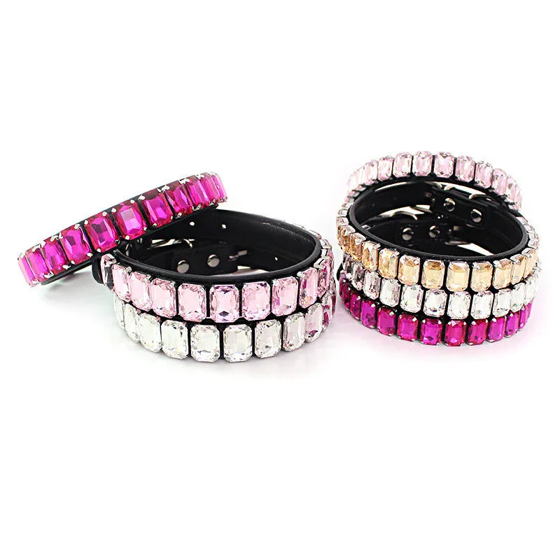 A set of glittering rhinestone dog collars featuring pink and clear crystal accents.
