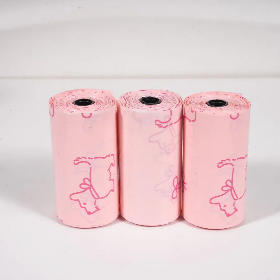 Three rolls of pink thick dog waste bags featuring mixed sweet patterns.