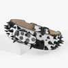 A black and white spotted spiked leather dog collar for large breeds.