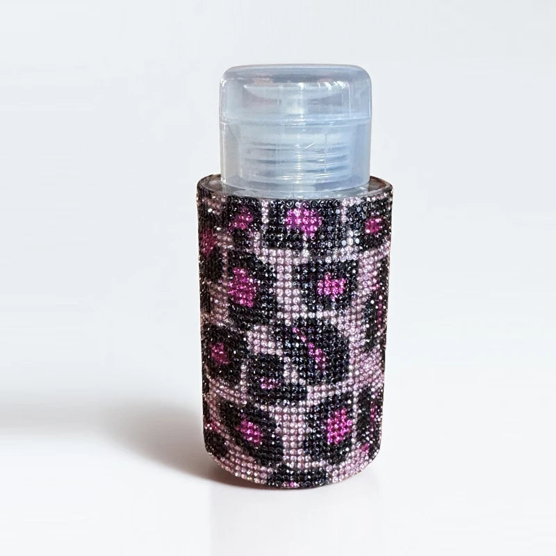 A refillable diamond design pump bottle for nail polish remover and makeup with a black and pink glitter pattern.