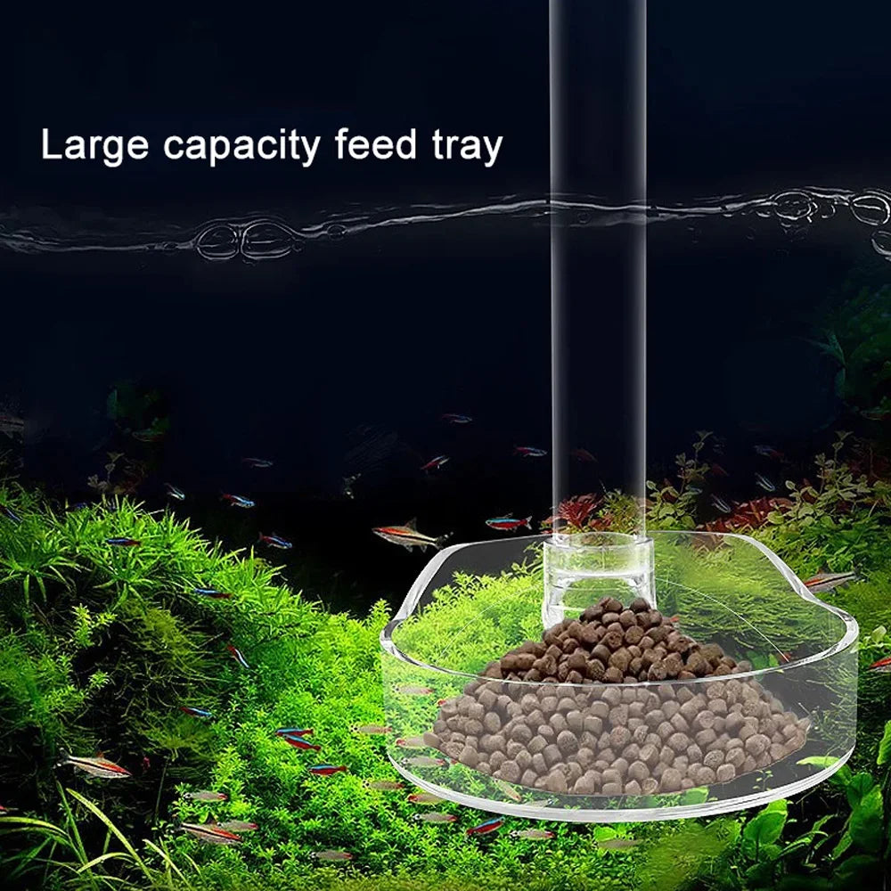 A large capacity feed tray is shown inside a transparent tube, with fish and aquatic plants visible below.