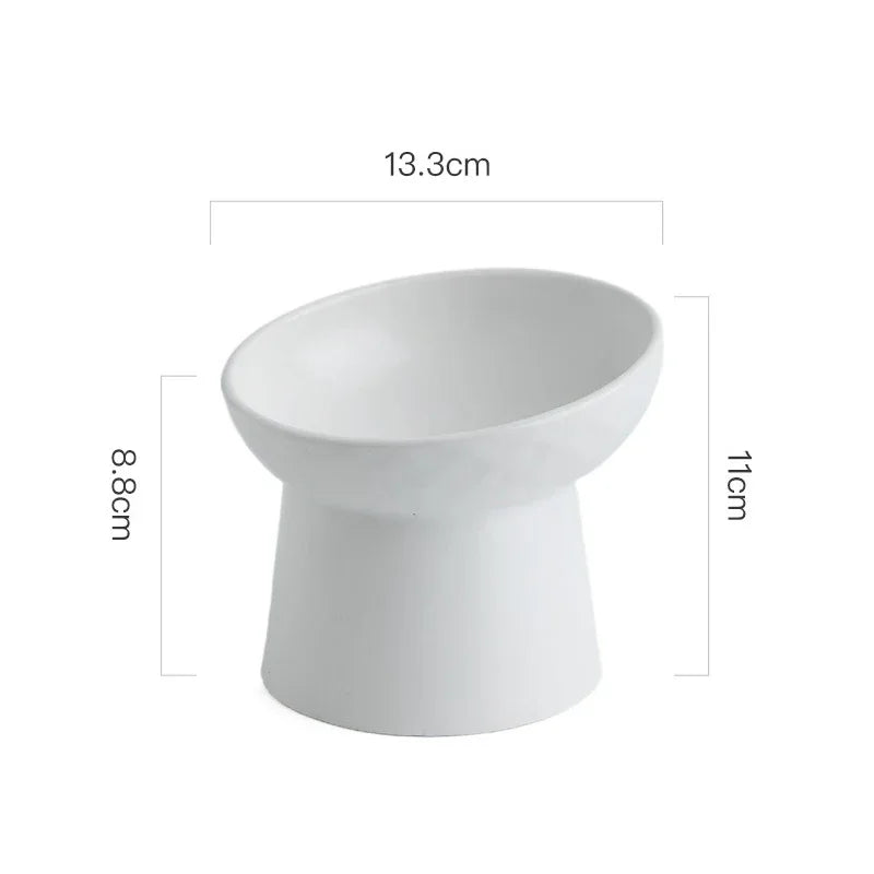 White elevated ceramic food bowl with a wide rim and a sturdy base.