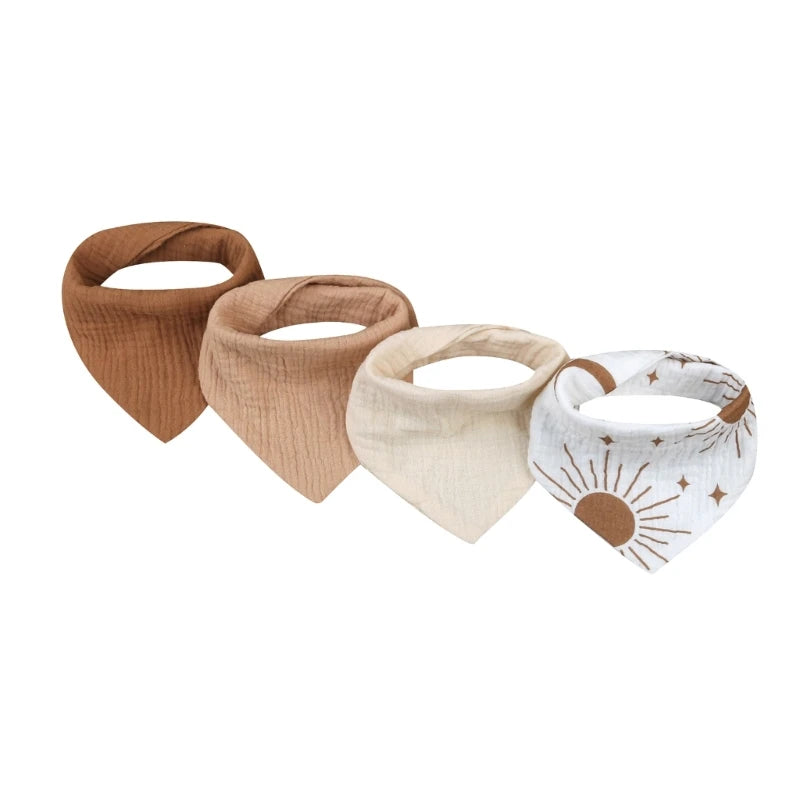 A set of four cotton baby bibs with different printed designs for newborns