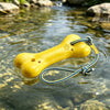 A yellow floating dog fetch toy with a paw print is visible in clear water.