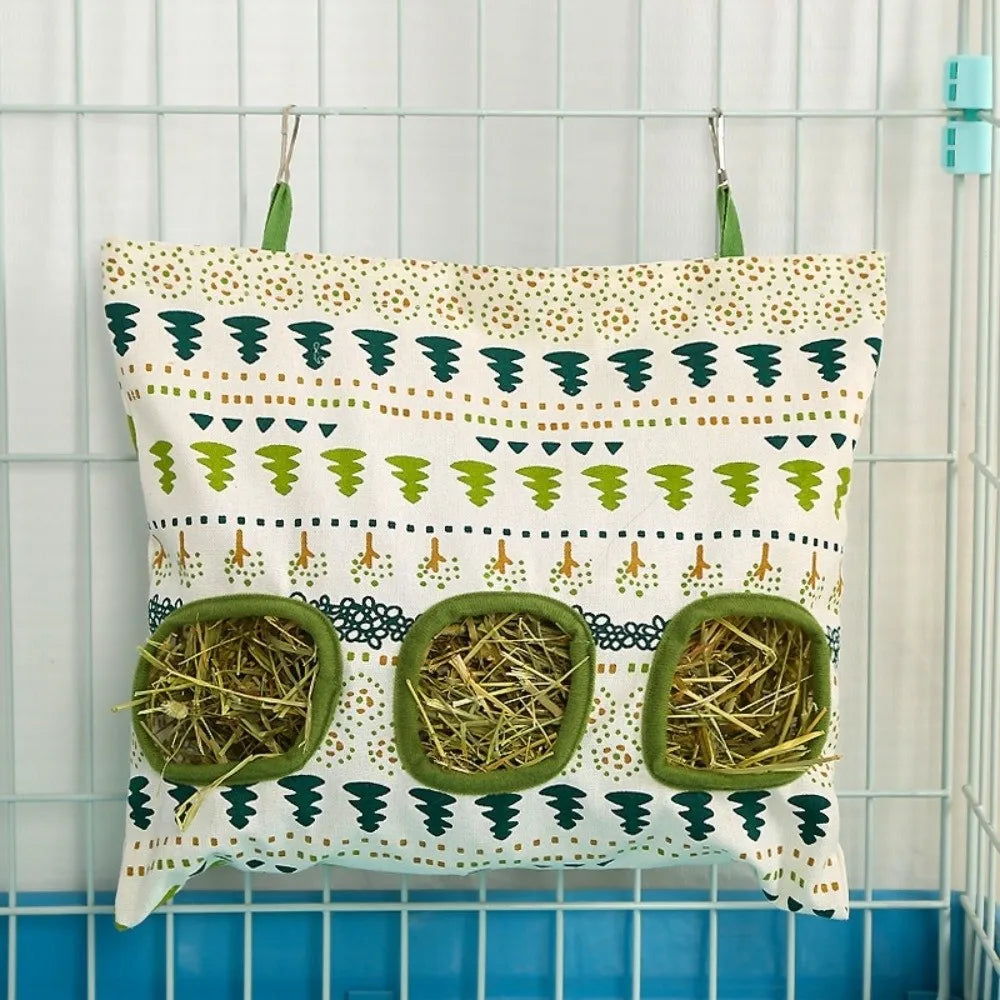 A fabric bag with a patterned design used as a multi-hole hay feeder for small animals.