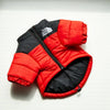 A red and black puffer coat for dogs with a zipper, displayed against a white background.