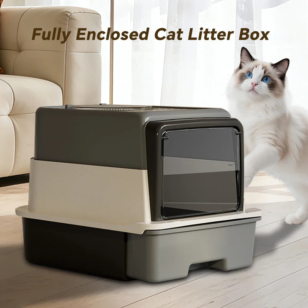 A fully enclosed cat litter box in gray and beige plastic sitting on a wooden floor next to a white cat.