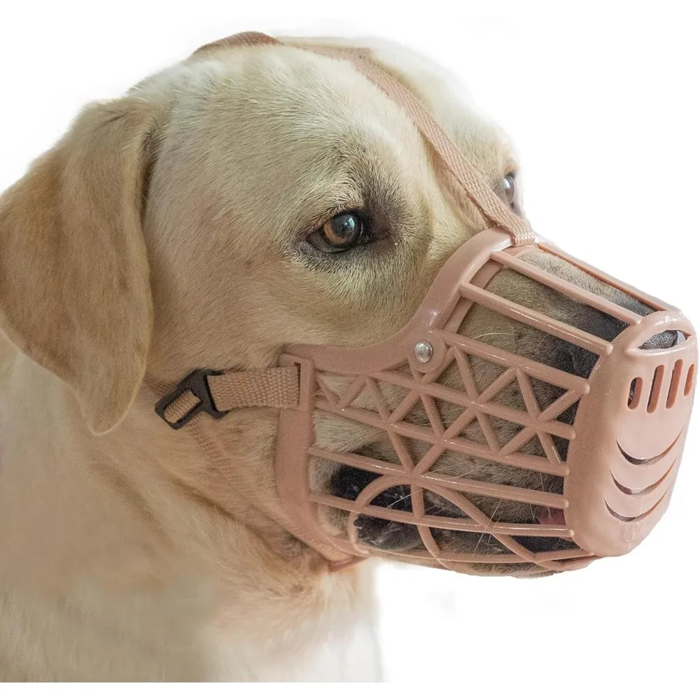 A light-colored dog wearing a pink adjustable anti-bite muzzle with a quick-release buckle.