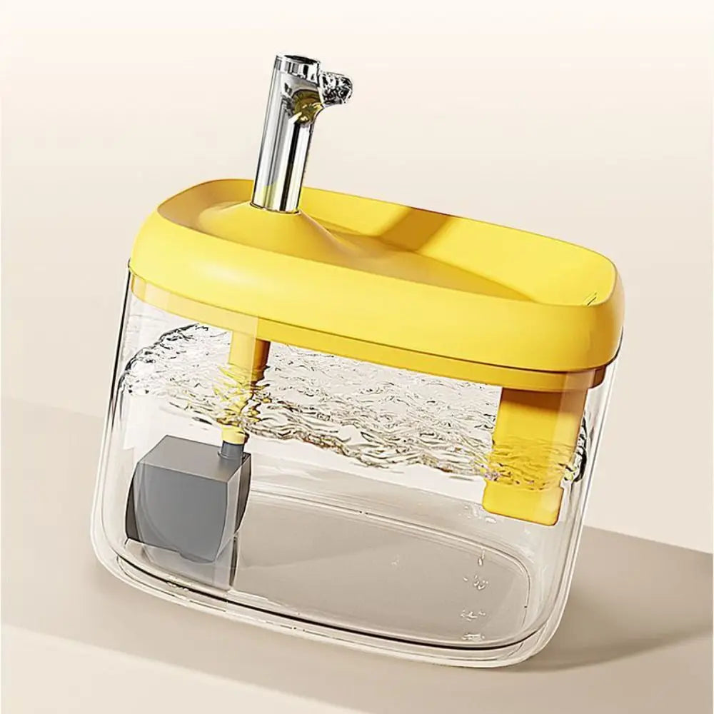 A clear pet drinking fountain with a yellow base and a silver spout, designed for large capacity water flow.