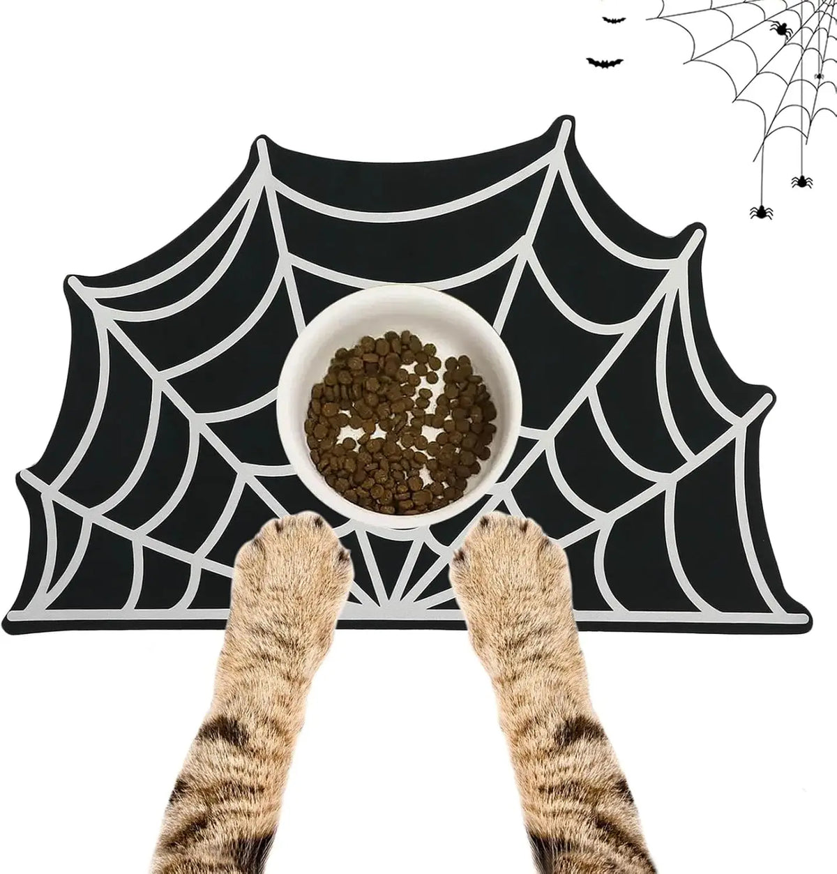 A black mat with a white spider web design features a bowl of pet food and two cat paws.